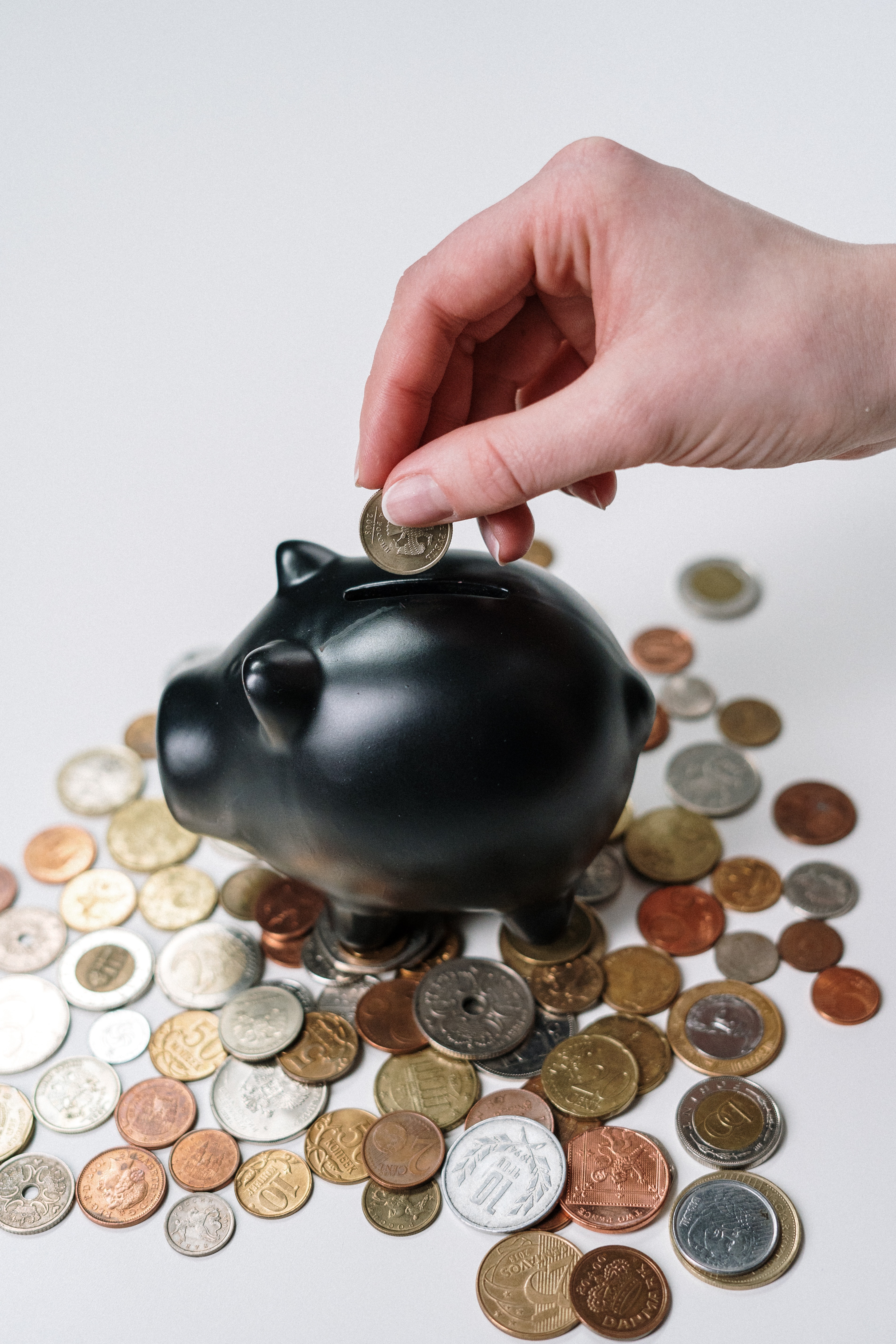 https://www.pexels.com/photo/person-putting-coin-in-a-piggy-bank-3943723/